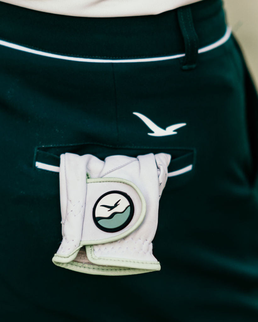 The Linksy women's golf glove tucked into the back pocket of the Linksy Stella golf shorts—effortlessly stylish and course-ready.