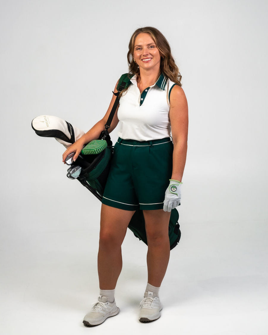 Margie Polo in white with Evergreen piping, a modern sleeveless golf polo designed for movement, breathability, and all-day wear.